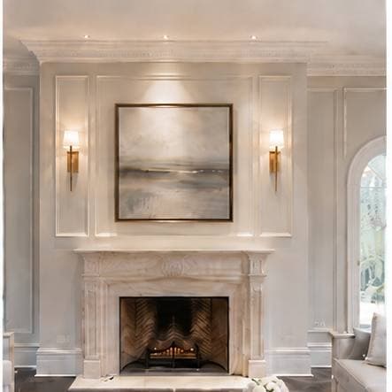 The same fireplace wall after skim coating and restoration β smooth and repainted